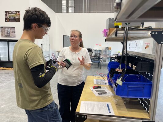 An instructor and student having a conversation at the BCI Skills Center
